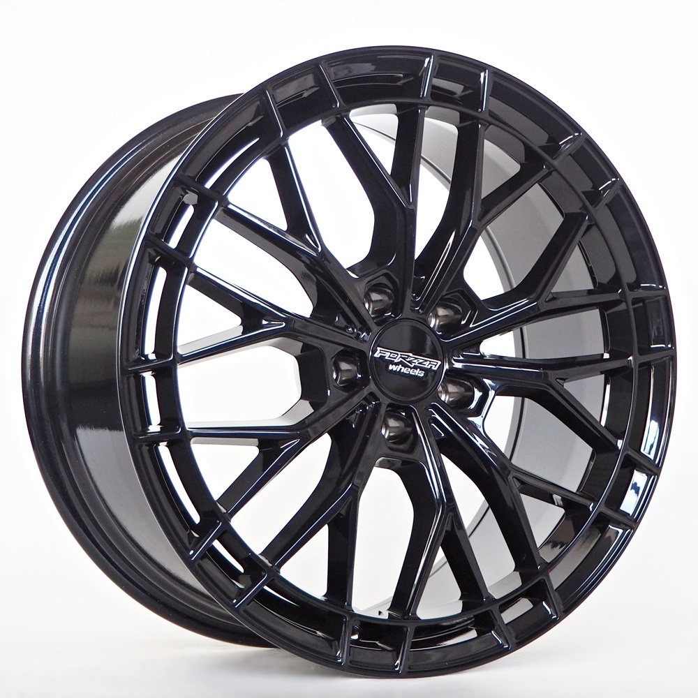 OLYMPUS DIGITAL CAMERA Black glossy alloy car wheel with a complex multi-spoke design and a center cap badge on white background.