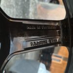 Close-up of a car window frame with embossed text reading 'Made in Germany' along the chrome trim.