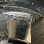 Close-up of a Mercedes steering wheel with the Mercedes badge and a model/part number plate (A2134013200).