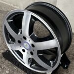 Close-up of a Mercedes-Benz alloy wheel with black and silver spokes and the Mercedes emblem at the center