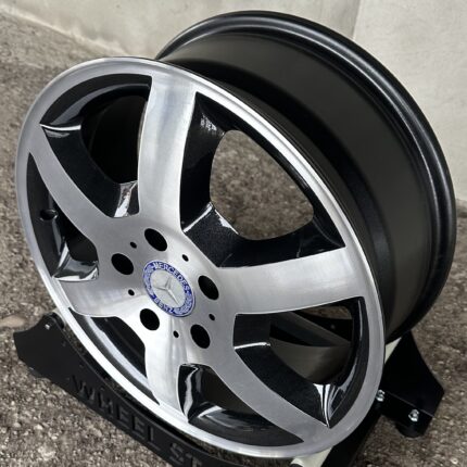 Close-up of a Mercedes-Benz alloy wheel with black and silver spokes and the Mercedes emblem at the center