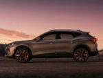 Silver SUV parked on a road at sunset, highlighting its sleek design and large alloy wheels.