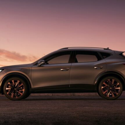 Silver SUV parked on a road at sunset, highlighting its sleek design and large alloy wheels.
