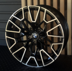 Black and silver BMW alloy wheel with an intricate geometric spoke design and a central BMW logo.