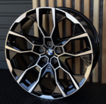 Close-up of a black and silver BMW alloy wheel with a geometric, multi-spoke pattern and central BMW emblem.