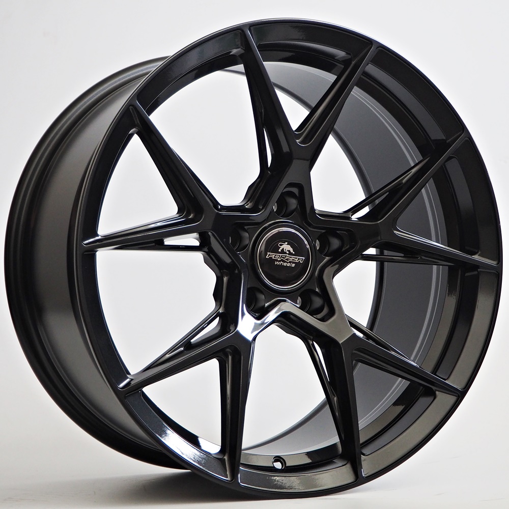 OLYMPUS DIGITAL CAMERA Black multi-spoke alloy car wheel with a centered logo cap reading 'FORGE wheels' (Forza Wheels) against a light background