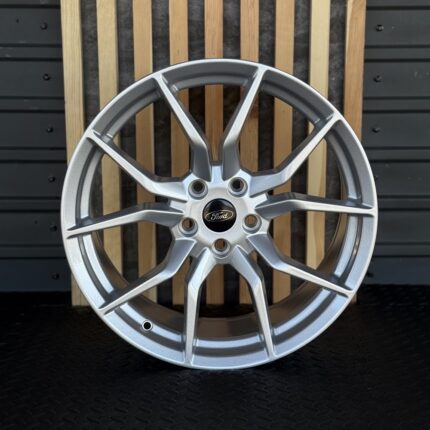 Silver Ford alloy wheel with a multi-spoke design and center emblem
