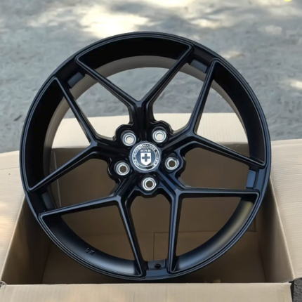 Black alloy wheel with a split-spoke design in a box; center cap reads HRE Performance Wheels.