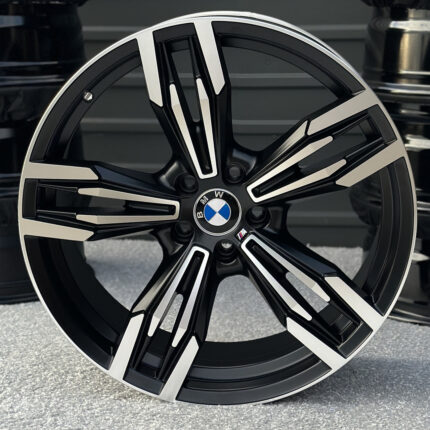 BMW alloy wheel with black and silver spokes and a center BMW logo cap.