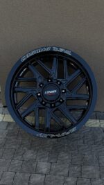 Cosmis Devil aftermarket car wheel in glossy dark blue with a multi-spoke design against a wall backdrop.