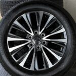 Close-up of an alloy wheel with a Lexus center cap and a black tire